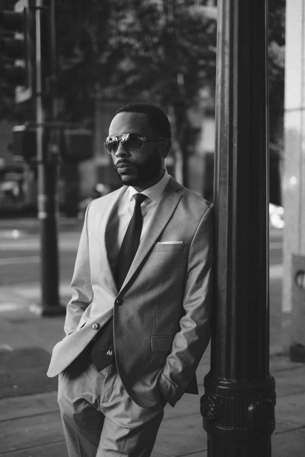 Anthony Hughes, Jr. in a tailored suit on a city street